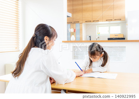 Parents and children studying in the living room Parents and children studying in the living room 140922995