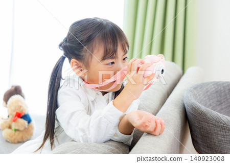 A child taking pictures with a toy camera A child taking pictures with a toy camera 140923008
