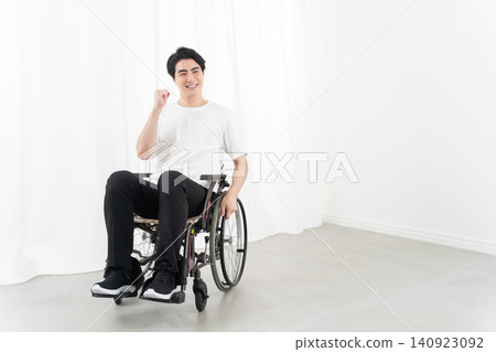 A young man in a wheelchair due to an injury. A young man in a wheelchair due to an injury. 140923092