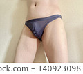 A man with metabolic syndrome in his underwear, facing right, wearing blue. 140923098