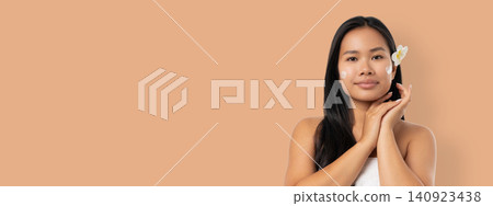 Woman enjoys skincare routine in spa with a product on her face Woman enjoys skincare routine in spa with a product on her face 140923438