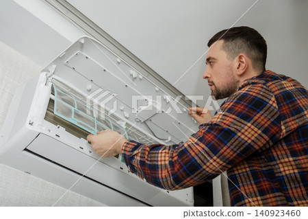 Air conditioner technician inspects and cleans HVAC system components Air conditioner technician inspects and cleans HVAC system components 140923460