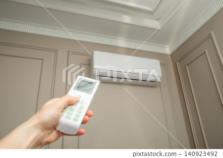 Air conditioner cools indoor environment. Comfort and modern technology concept Air conditioner cools indoor environment. Comfort and modern technology concept 140923492