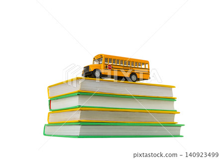 Colorful books with a yellow bus toy, isolated on white, PNG Colorful books with a yellow bus toy, isolated on white, PNG 140923499