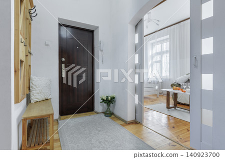 Apartment Entrance Hallway with Dark Door and Living Room View Apartment Entrance Hallway with Dark Door and Living Room View 140923700