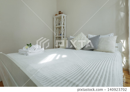Cozy Bedroom Interior with Fresh Towels and Rose on Bed 140923702