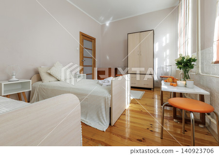 Twin Bedroom Interior with Wooden Furniture and Cozy Decor Twin Bedroom Interior with Wooden Furniture and Cozy Decor 140923706