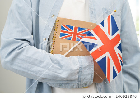 Learn English language, Asian teenage student hold book with flag in course at school. Learn English language, Asian teenage student hold book with flag in course at school. 140923876