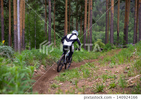 Back view downhill racer riding Back view downhill racer riding 140924166