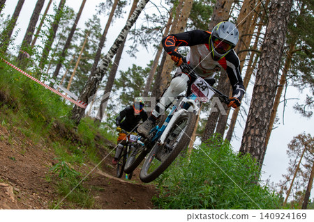 Two athletes racer riding downhill 140924169
