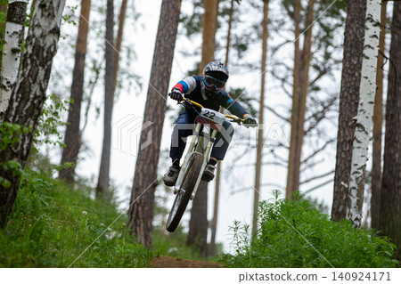 Athlete racing jumped over hill Athlete racing jumped over hill 140924171