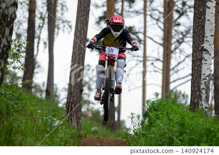 Downhill racer with action camera on helmet 140924174