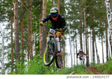 Athlete racer jumped over hill Athlete racer jumped over hill 140924177