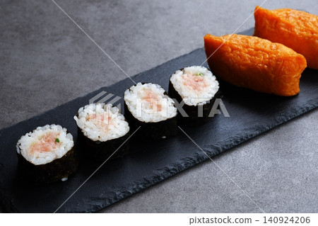 Negitoro rolls and inari sushi - A delicious-looking set of negitoro rolls and inari sushi 140924206