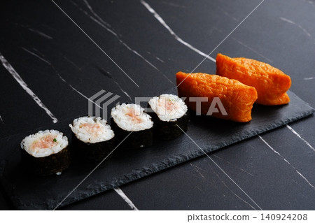 Negitoro rolls and inari sushi - A delicious-looking set of negitoro rolls and inari sushi Negitoro rolls and inari sushi - A delicious-looking set of negitoro rolls and inari sushi 140924208