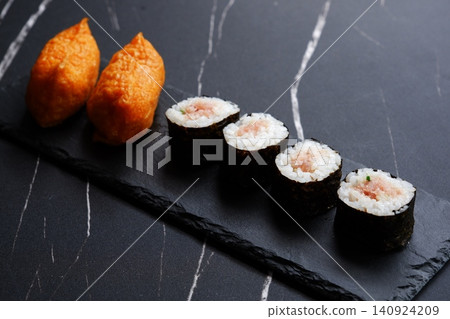 Negitoro rolls and inari sushi - A delicious-looking set of negitoro rolls and inari sushi 140924209