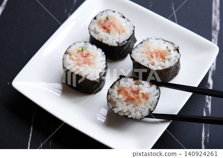 Negitoro roll - The classic thin sushi roll is negitoro roll, which is made by wrapping tuna and green onions. Negitoro roll - The classic thin sushi roll is negitoro roll, which is made by wrapping tuna and green onions. 140924261
