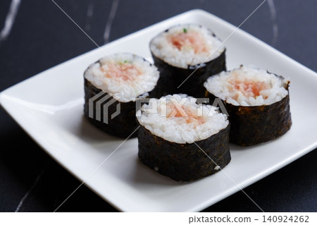 Negitoro roll - The classic thin sushi roll is negitoro roll, which is made by wrapping tuna and green onions. Negitoro roll - The classic thin sushi roll is negitoro roll, which is made by wrapping tuna and green onions. 140924262