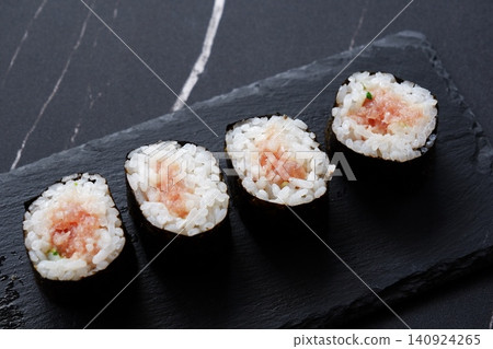 Negitoro roll - The classic thin sushi roll is negitoro roll, which is made by wrapping tuna and green onions. Negitoro roll - The classic thin sushi roll is negitoro roll, which is made by wrapping tuna and green onions. 140924265