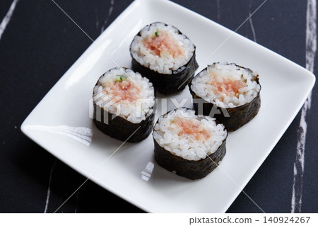 Negitoro roll - The classic thin sushi roll is negitoro roll, which is made by wrapping tuna and green onions. Negitoro roll - The classic thin sushi roll is negitoro roll, which is made by wrapping tuna and green onions. 140924267
