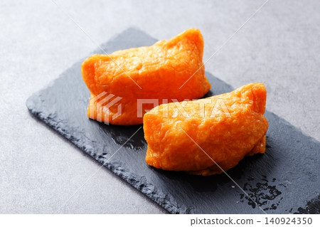 Inarizushi - Sweet and spicy fried tofu stuffed with vinegared rice Inarizushi - Sweet and spicy fried tofu stuffed with vinegared rice 140924350