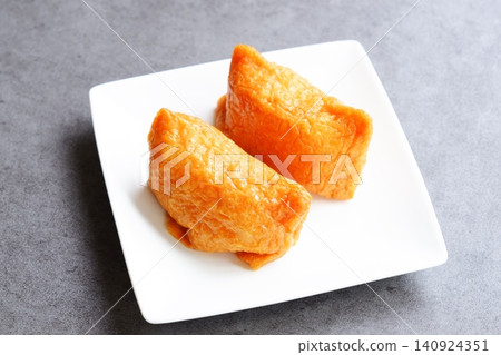Inarizushi - Sweet and spicy fried tofu stuffed with vinegared rice Inarizushi - Sweet and spicy fried tofu stuffed with vinegared rice 140924351