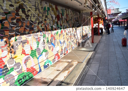 Nakamise Street in Asakusa, Tokyo, in springtime; the shopping street before opening in the morning; shutters depicting the seasons of Asakusa. Nakamise Street in Asakusa, Tokyo, in springtime; the shopping street before opening in the morning; shutters depicting the seasons of Asakusa. 140924647