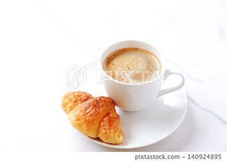Croissants and Coffee - A breakfast scene with freshly baked croissants and freshly brewed cafe au lait Croissants and Coffee - A breakfast scene with freshly baked croissants and freshly brewed cafe au lait 140924895