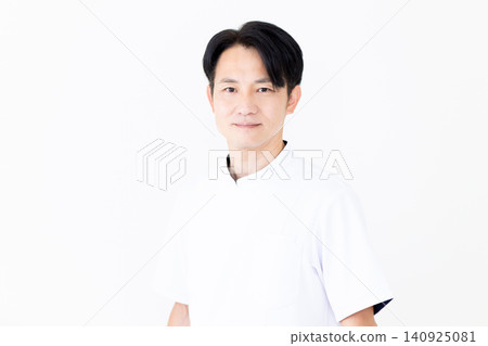 A middle-aged male acupuncturist/osteopath wearing a white coat. A middle-aged male acupuncturist/osteopath wearing a white coat. 140925081