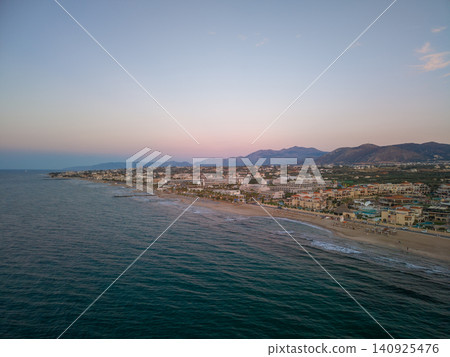 Drone View of Mediterranean Sea and Long Beach Resort in Crete at Dusk Drone View of Mediterranean Sea and Long Beach Resort in Crete at Dusk 140925476