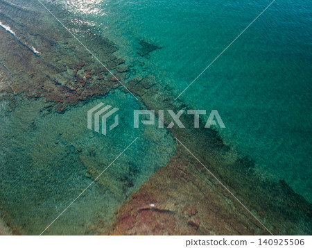 Top Down Aerial View of Clear Turquoise Sea with Submerged Rocks Top Down Aerial View of Clear Turquoise Sea with Submerged Rocks 140925506