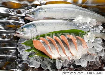 A photograph showing fresh, plump autumn salmon and fillets arranged against a backdrop of fresh, vibrant kelp. A photograph showing fresh, plump autumn salmon and fillets arranged against a backdrop of fresh, vibrant kelp. 140925600