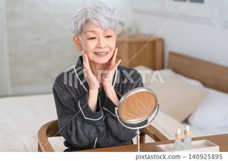 Senior woman doing skin care beauty image Senior woman doing skin care beauty image 140925895