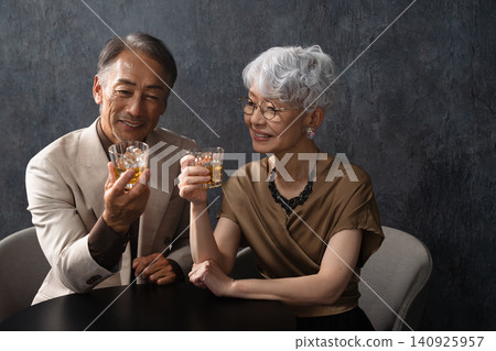 Senior men and women drinking brandy Lifestyle image Senior men and women drinking brandy Lifestyle image 140925957