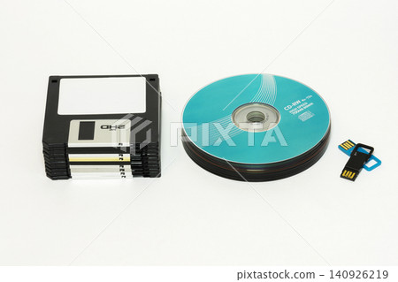 Floppy disks, CD / DVD disk and USB flash on a white background Floppy disks, CD / DVD disk and USB flash on a white background 140926219
