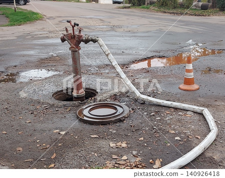 A fire standpipe installed on an underground hydrant to draw water from the water supply network. A fire standpipe is used by firefighters to connect fire hoses and fill the tanks of fire trucks with 140926418