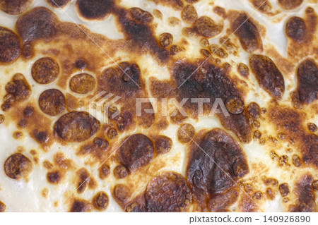 Golden Brown Texture of Bubbly Flatbread Surface - Ideal for Culinary Design and Food Backgrounds 140926890