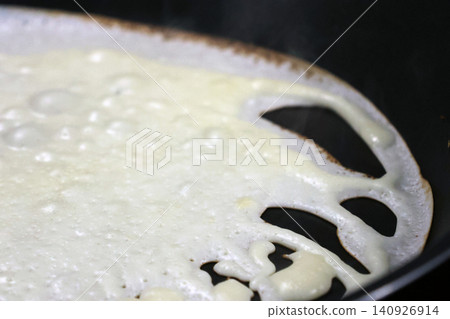 Close-Up of Crepe on Skillet: Texture and Cooking Process Close-Up of Crepe on Skillet: Texture and Cooking Process 140926914
