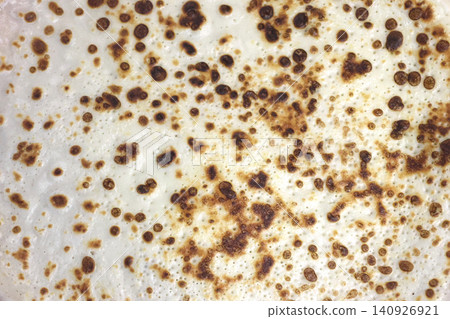 Close-Up of Golden Brown Pancake Surface with Bubbles for Culinary Design Close-Up of Golden Brown Pancake Surface with Bubbles for Culinary Design 140926921