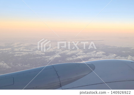 Aerial View of Snow-Capped Mountains at Sunrise from Airplane Window Aerial View of Snow-Capped Mountains at Sunrise from Airplane Window 140926922