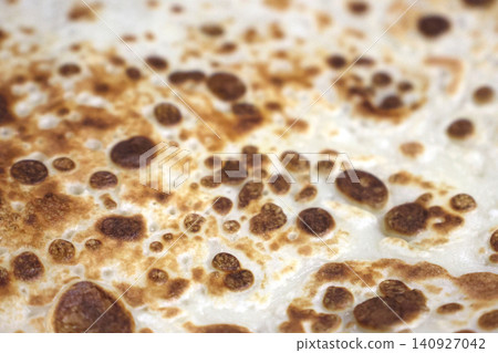Close-Up of Golden Brown Crepe Pancake Surface Texture 140927042
