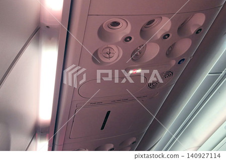 Control panel on airplane cabin showing lights and buttons for passengers and crew during flight 140927114