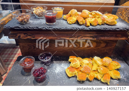 People enjoy sweet treats at a food market in a busy city during an event in the evening People enjoy sweet treats at a food market in a busy city during an event in the evening 140927157