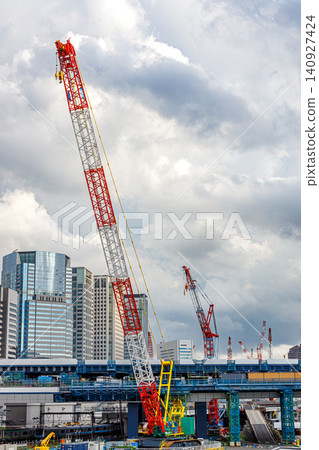Cranes and city buildings towering over the area around Takanawa Gateway Station Cranes and city buildings towering over the area around Takanawa Gateway Station 140927424