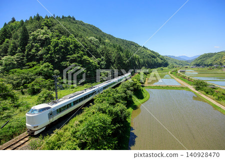 A limited express train on the San'in Main Line speeds from Kinosaki to Osaka, passing by rice paddies where planting has just finished. A limited express train on the San'in Main Line speeds from Kinosaki to Osaka, passing by rice paddies where planting has just finished. 140928470