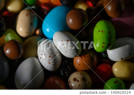 Explore the vibrant world of colorful candy-coated treats in a delightful assortment of shapes and sizes Explore the vibrant world of colorful candy-coated treats in a delightful assortment of shapes and sizes 140928524