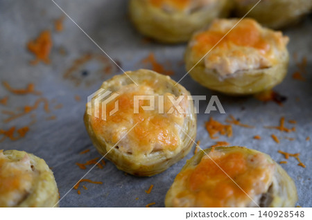 Mouthwatering savory pastries filled with cheese and herbs baked to perfection at an afternoon gathering 140928548