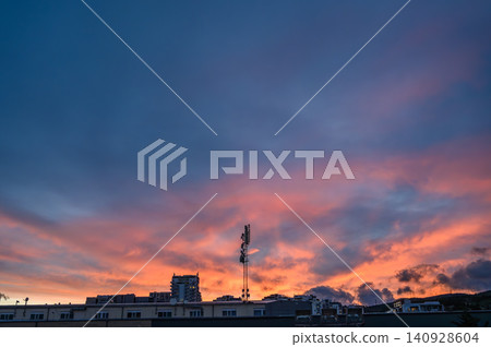 Twilight sunset over city skyline with orange and purple sky Twilight sunset over city skyline with orange and purple sky 140928604