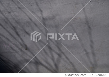 Tree branch shadows on plastered wall texture background Tree branch shadows on plastered wall texture background 140928685