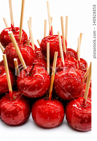 Candy Apples on White Background, Glossy Red Caramel Apples with Wooden Sticks Candy Apples on White Background, Glossy Red Caramel Apples with Wooden Sticks 140928858